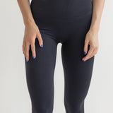 Raeya Fit's best-selling Waist Snatch leggings, perfect for those seeking comfortable, affordable, and sustainable black leggings. These ultra high-waisted leggings feature a 25" inseam, a double-band to flatten the stomach, and a rubber band at the top to snatch the waist. Made from eco-friendly fabric using post-consumer recycled content, they offer both style and sustainability, making them an ideal choice for women looking for the perfect leggings.